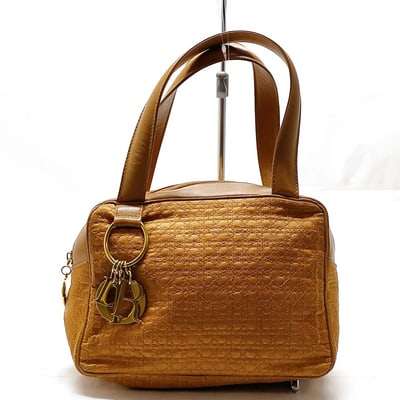 Dior golden/camel leather & raffia Miss Dior satchel: For sale is an exquisite Dior golden/camel colored leather and raffia Miss Dior satchel, a timeless piece that embodies luxury and sophistication. This iconic handbag features two elegant flat leather