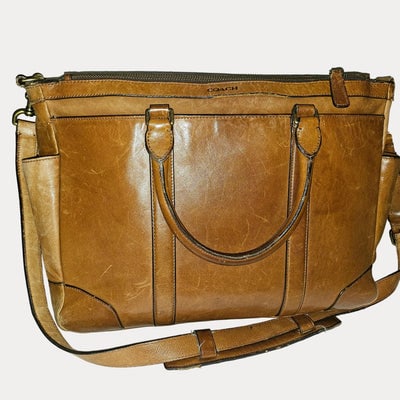 Coach light brown leather Bleeker Leather Business Tote w strap: For sale is an authentic Coach light brown leather Bleeker Leather Business Tote from 2014, a timeless piece perfect for the modern professional. This versatile bag features supple tan leather constru