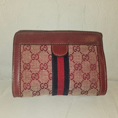 Gucci red Guccissima print & red leather clutch w Sherry stripe: For sale is an authentic Gucci red Guccissima print and red leather clutch, a coveted vintage piece featuring the brand's signature monogram pattern. This iconic style showcases a striking blue and re