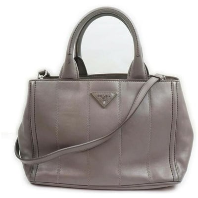 Prada Vitello Daino Top Handle Two Way Grey Leather Chrome Satchel: For sale is a Prada, Vitello Daino, supple grey leather, top handle two-way satchel with two, rolled, leather handles, a removable and adjustable strap, bold chrome hardware, snaps so the purse can ex