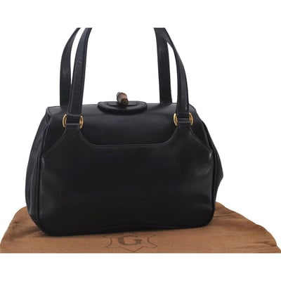 Mod Gucci, black leather shoulder bag with two longer straps, two exterior pockets, a hinged: ONE OF A KIND STYLE! For sale is a Gucci, black leather shoulder bag with two longer straps, two exterior pockets, a hinged opening, and a gold and bamboo accent clasp! This is a unique, shoulder purs