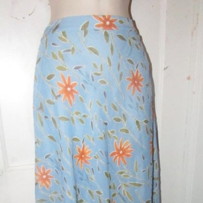 NWT, Moschino, size 46 IT/12 US, periwinkle, midi A-line skirt with stylized orange & green floral: For sale is a NWT, Moschino, blue viscose/polyester blend midi length skirt with embroidered orange flowers and green vines, an a-line cut, built in lining, and side zip closure! This is the perfect p