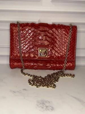 Ferragamo red python two way cross body: For sale is an authentic Ferragamo red python two way cross body bag, a timeless luxury piece that seamlessly transitions between seasons and occasions. This sophisticated design features supple red p