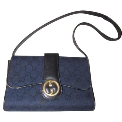 Gucci, deep blue Guccissima print canvas and black leather, envelope top, 1973 two-way-shoulder: For sale is a Gucci, RARE, bohemian/mod, deep blue Guccissima print canvas and black leather, envelope top, 1973 two-way-shoulder purse or clutch with a bold gold tone round 'GG' logo accent at the ce