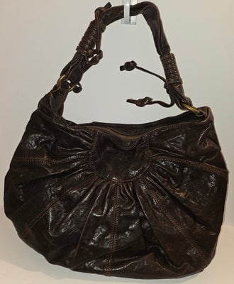 Dolce & Gabbana brown leather XL hobo with a bow & brass studs: For sale is an authentic Dolce & Gabbana brown leather XL hobo bag, a timeless luxury piece perfect for the vintage fashion enthusiast. This spacious tote features rich, supple brown leather const