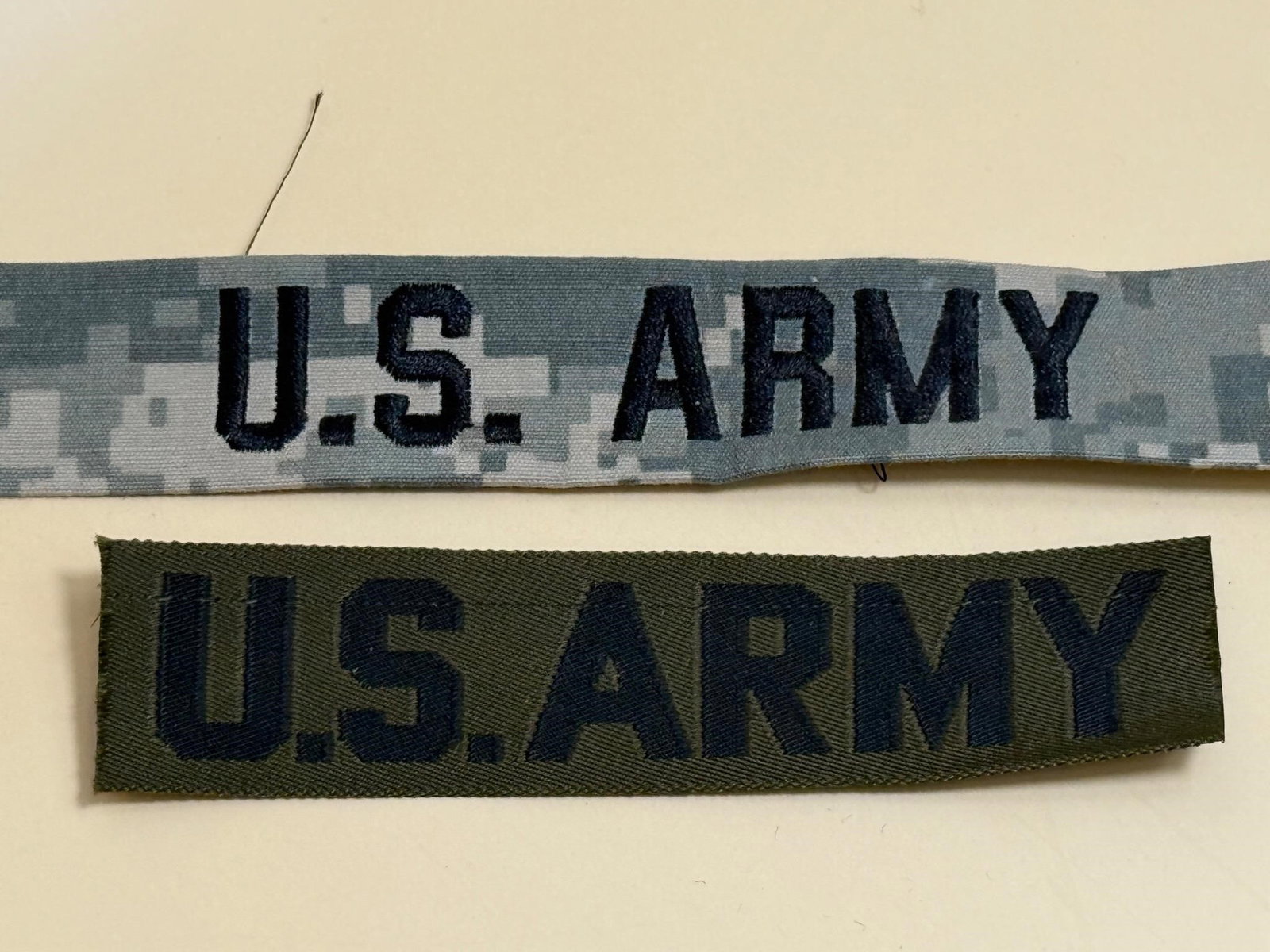U.S. Army Name Tapes: U.S. Army name tapes, which are fabric strips worn on military uniforms for identification purposes. Dimensions: 4.5in x1in, 8in x1in