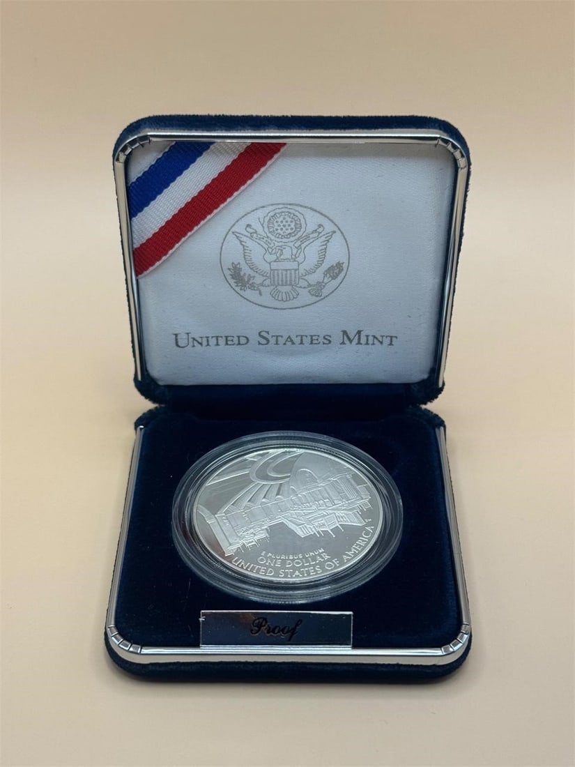 2005 Chief Justice John Marshall Silver Dollar: US MintBox Dimensions: 6in x 3.5in x ¾ in2005 Chief Justice John Marshall Silver Dollar, a commemorative coin issued by the U.S. Mint.Includes certificate of authenticity, blue velvet box.