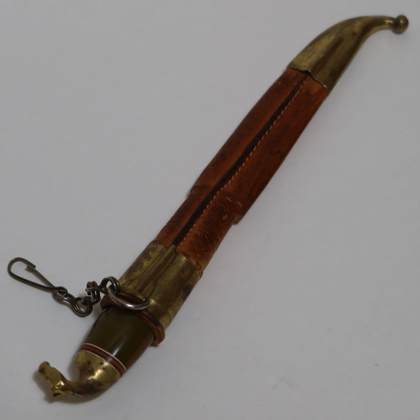 Vintage Scandinavian Puukko-Style Knife: Vintage Scandinavian puukko-style knife with a polished horn-like handle fitted with brass ferrules. The pommel is shaped into a small animal head, a common Lapland decorative style. Blade is a narrow