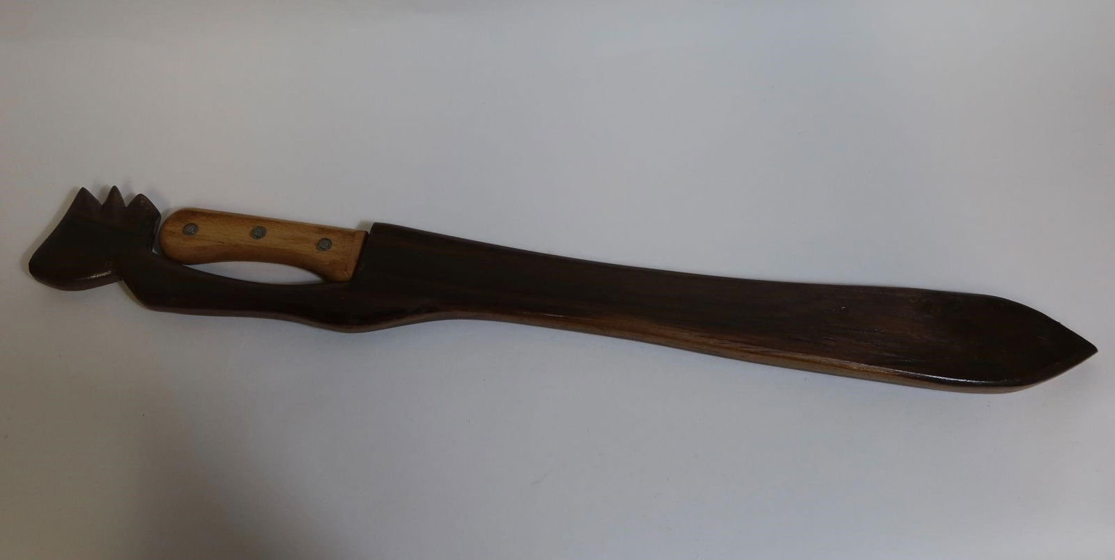 WWII British Martindale Birmingham Machete: WWII British Martindale Birmingham machete with the crocodile logo, marked "Made in England." Features a simple wooden grip and comes in a carved wooden sheath with a decorative animal-head design. Sh