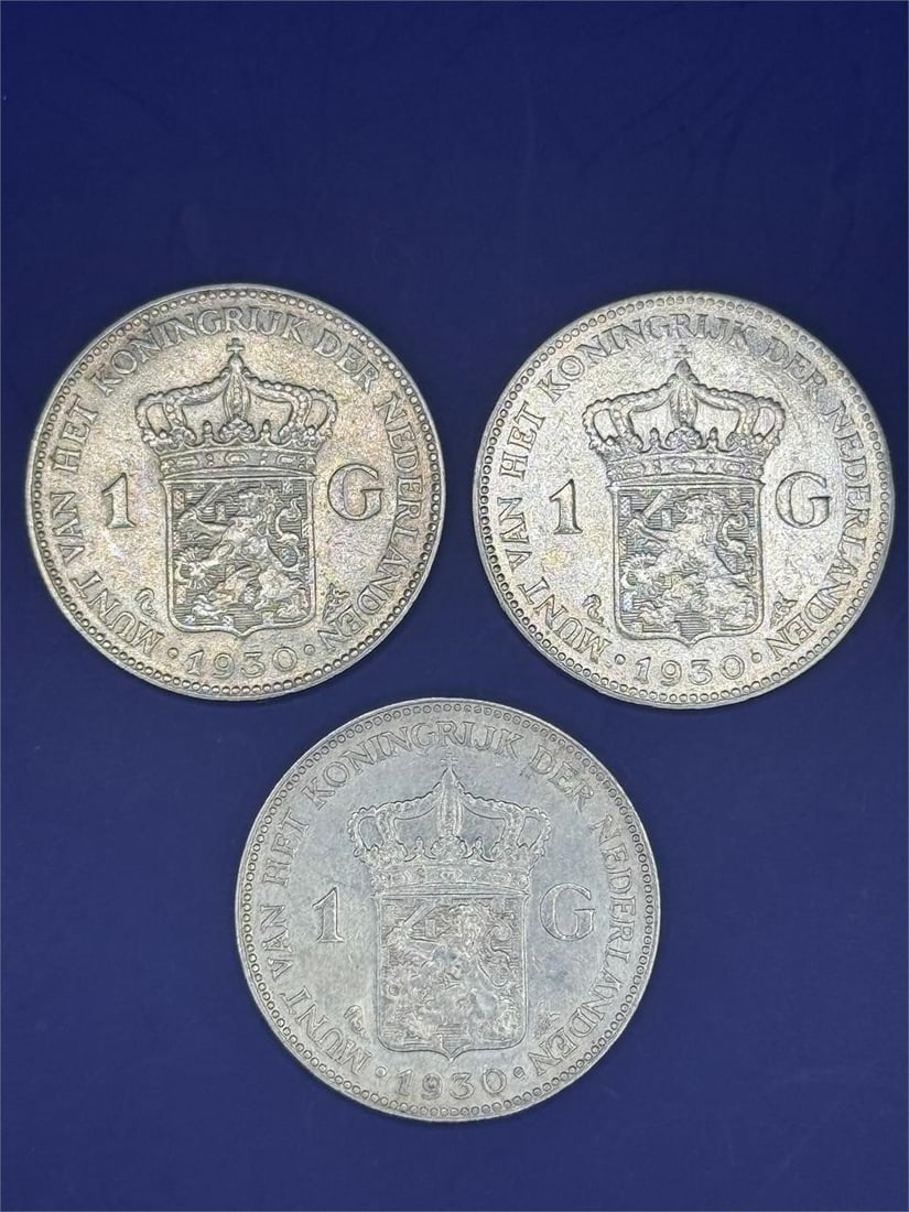 Set of 3, Netherlands 1 Gulden: Size:1inDated 1930Netherlands 1 Guldenoins featuring the Dutch coat of arms on one side and the reigning monarch, Queen Wilhelmina, on the other. These coins were minted between 1922 and 1945.
