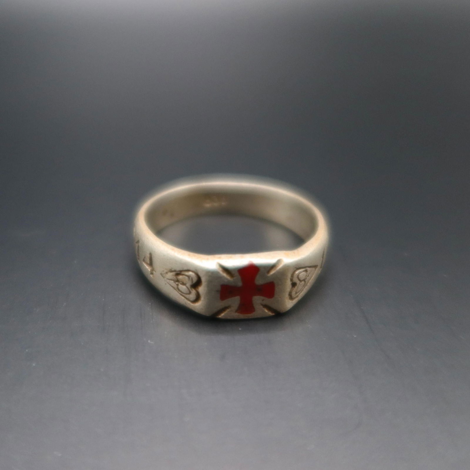 WWI German Silver Ring 1914-1917: WWI German Silver Ring Attractive early 20th-century silver band featuring a red enameled cross at the center and engraved dates "1914" and "1917" on the sides. The ring is marked 835 inside, indicati