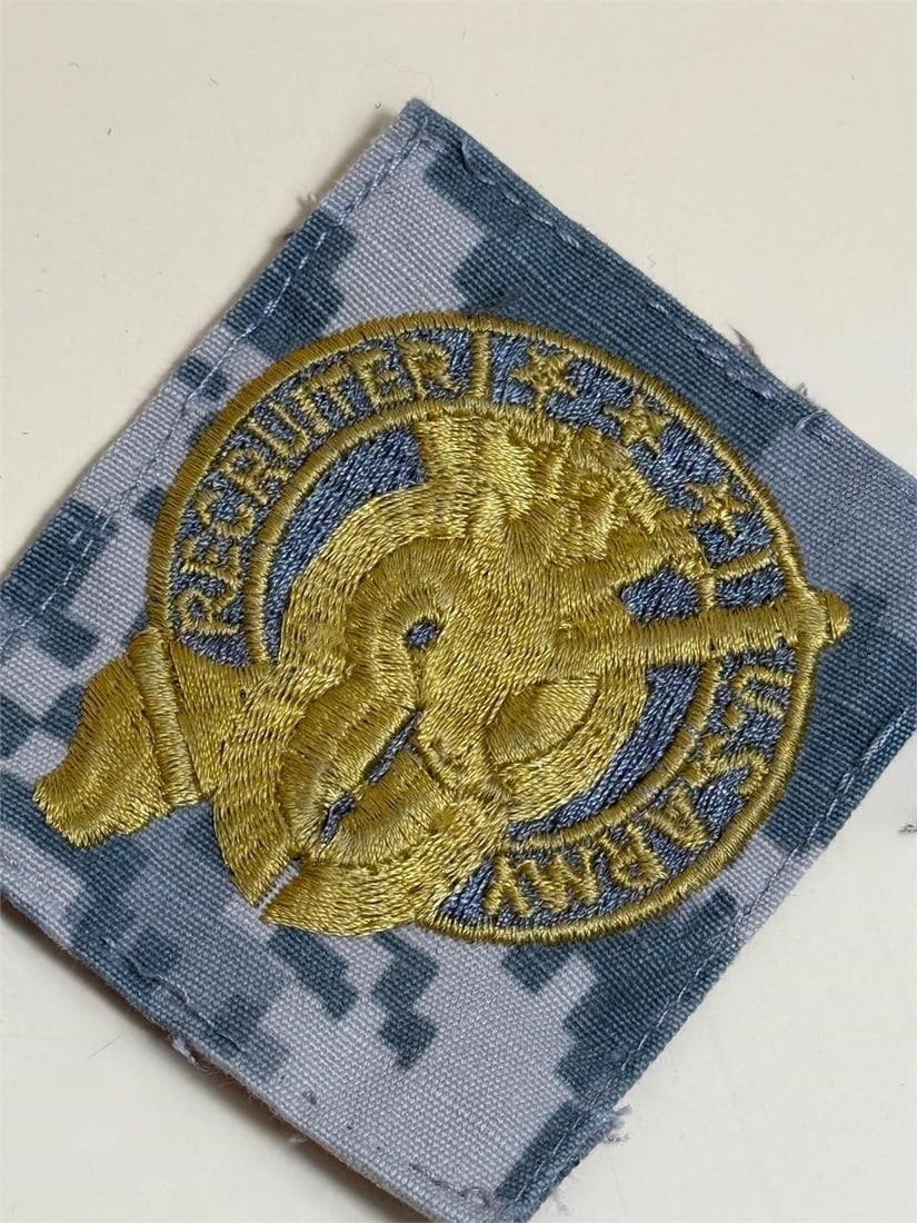 U.S. Army Recruiting Command patch: U.S. Army Recruiting Command patch, specifically designed for wear on the now-obsolete Army Combat Uniform (ACU) featuring the Universal Camouflage Pattern (UCP). The design features a