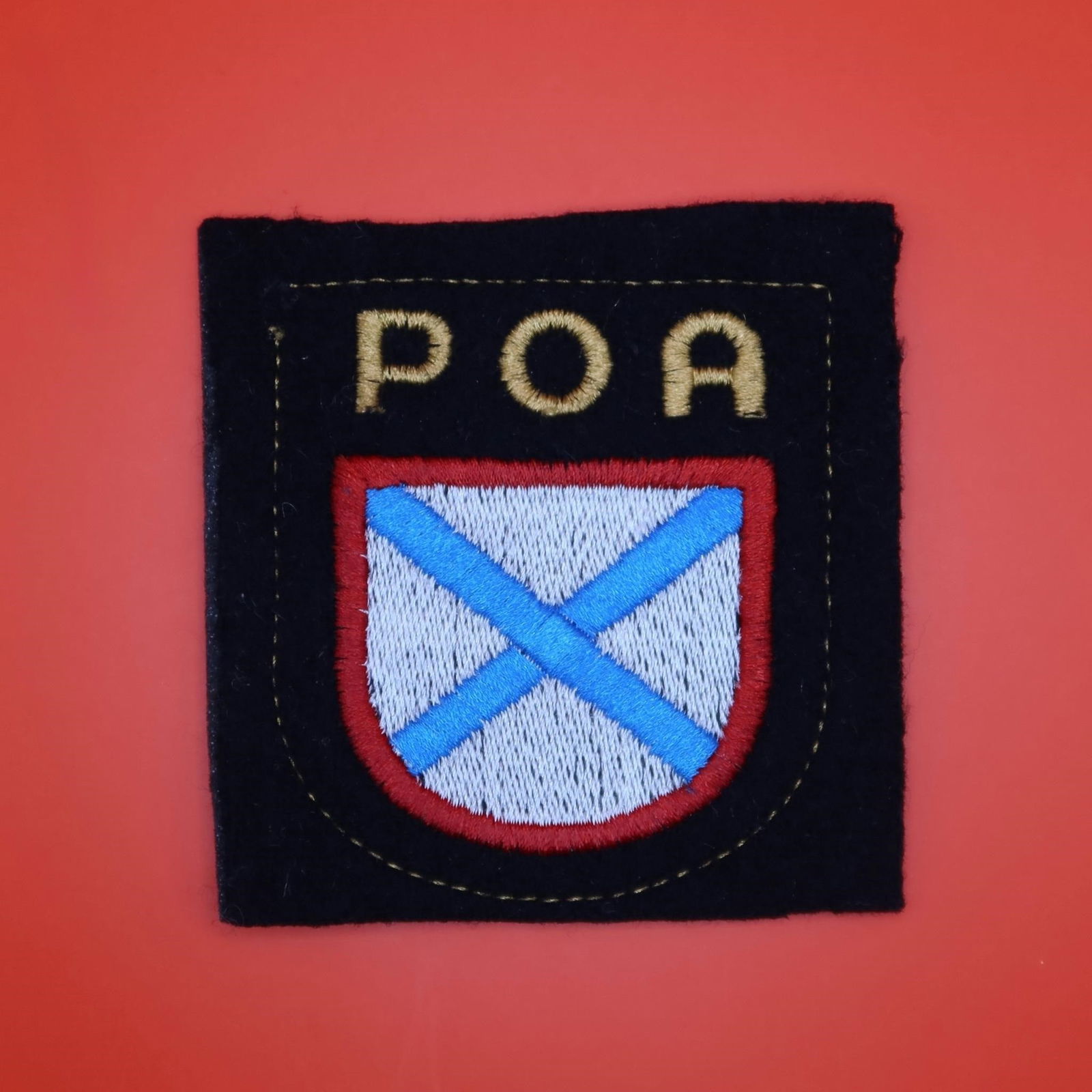WWII Russian POA Volunteer Sleeve Shield: Machine-woven early Bevo type on medium black rayon backing. Rectangular shield with crisp, raised Cyrillic letters "POA" (ROA in Latin letters) centered, tightly woven with clean edges and uniform