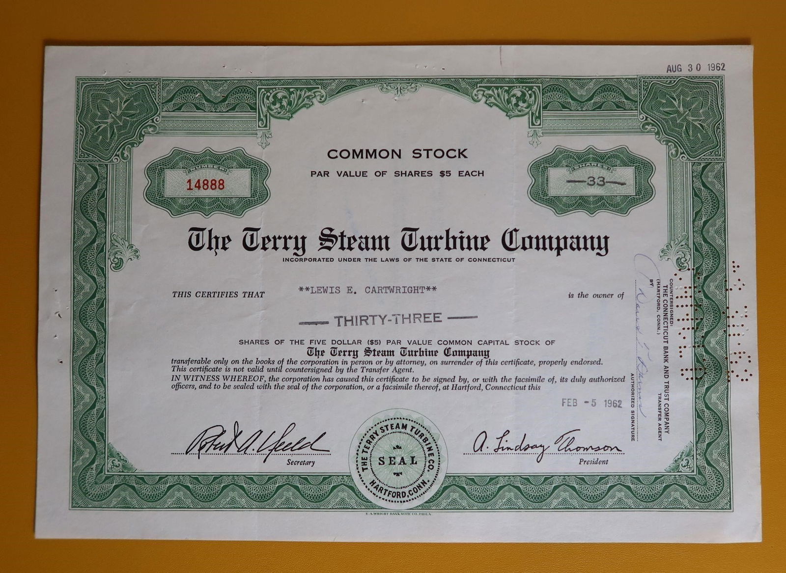 German WWII Tinnie - "Tag der Wehrmacht": A small WWII-era German fundraising tinnie featuring a raised sword across a round wreath with geometric backing. Made of darkened zinc alloy with a vertical pin on the reverse, marked "H4." These wer