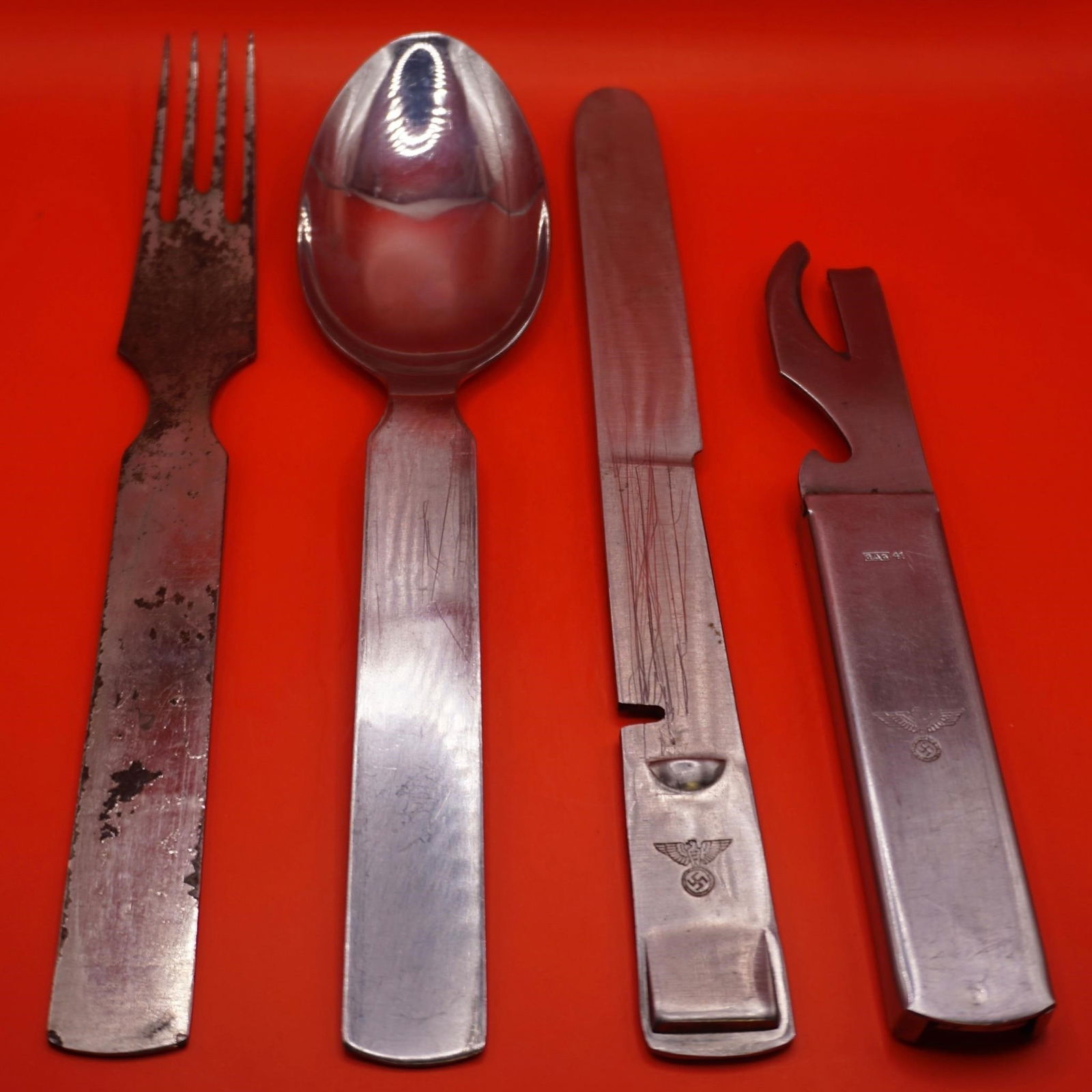 WWII German Wehrmacht Mess Kit Utensils Set: Original WWII German Wehrmacht mess kit utensils set, including knife, fork, spoon, and can opener, all stamped with Heer eagle. Knife, fork, and spoon marked "GAG" with wartime dates (1941-42). Locki