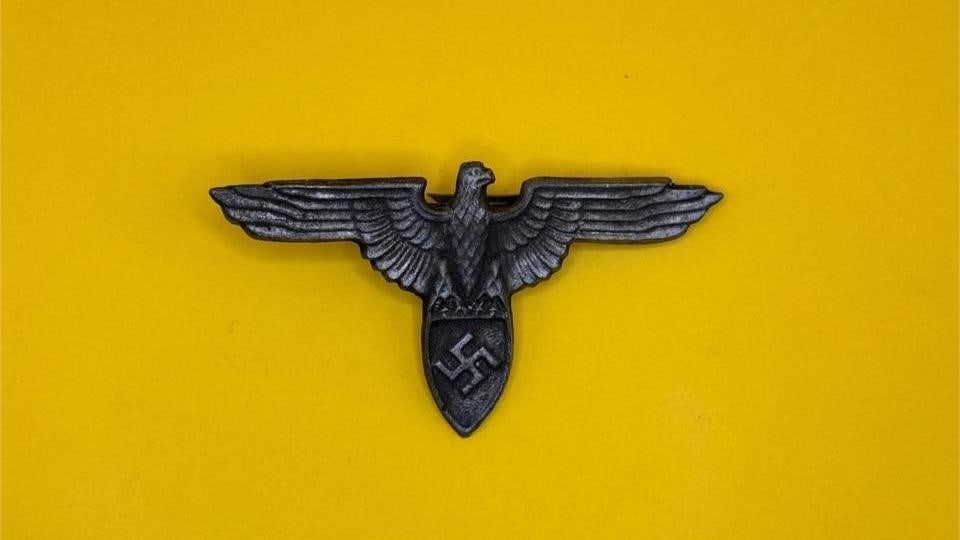 WWII SS Iron Eagle Hat Insignia: Worn on SS hats during WWII, this eagle signified membership and rank within the Schutzstaffel.