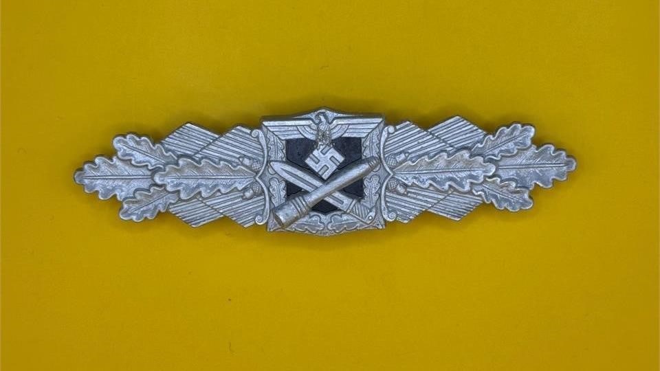 WWII German Close Combat Clasp: The Close Combat Clasp (Nahkampfspange), introduced on 25 November 1942, was awarded to German Army and Waffen-SS troops for hand-to-hand fighting at close quarters. It was issued in three classes to