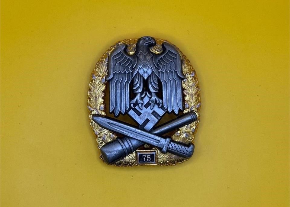 General Assault Badge 75: This numbered General Assault Badge ("75") was a late-war German award for repeated combat actions. Produced by C.E. Juncker, it features a semi-hollow design with riveted eagle and aluminum tombac nu