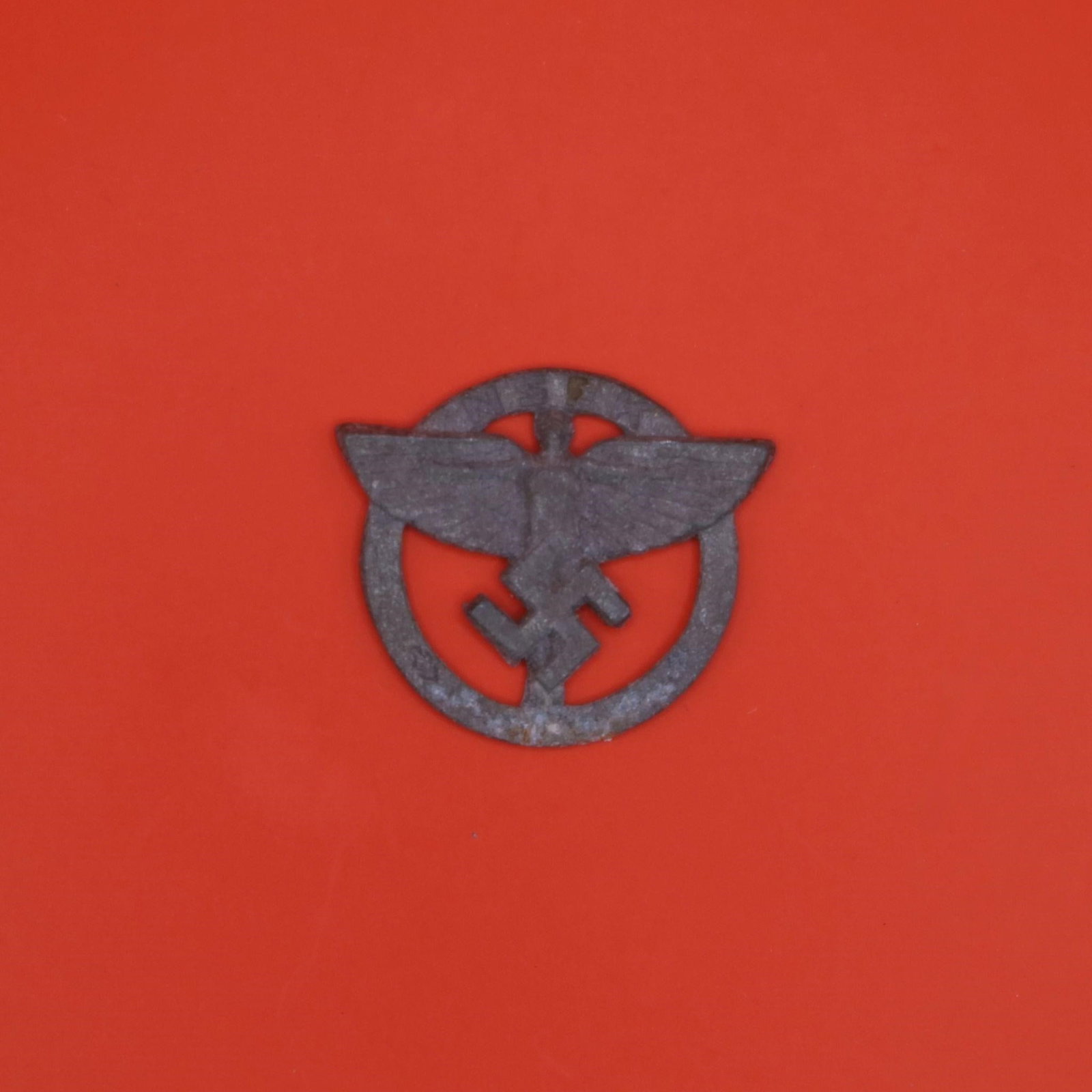 NSFK Member's Badge: This is a metal badge from the National Socialist Flyers Corps (NSFK), a paramilitary aviation organization active in Germany at the time. It features the group's winged-figure emblem within a