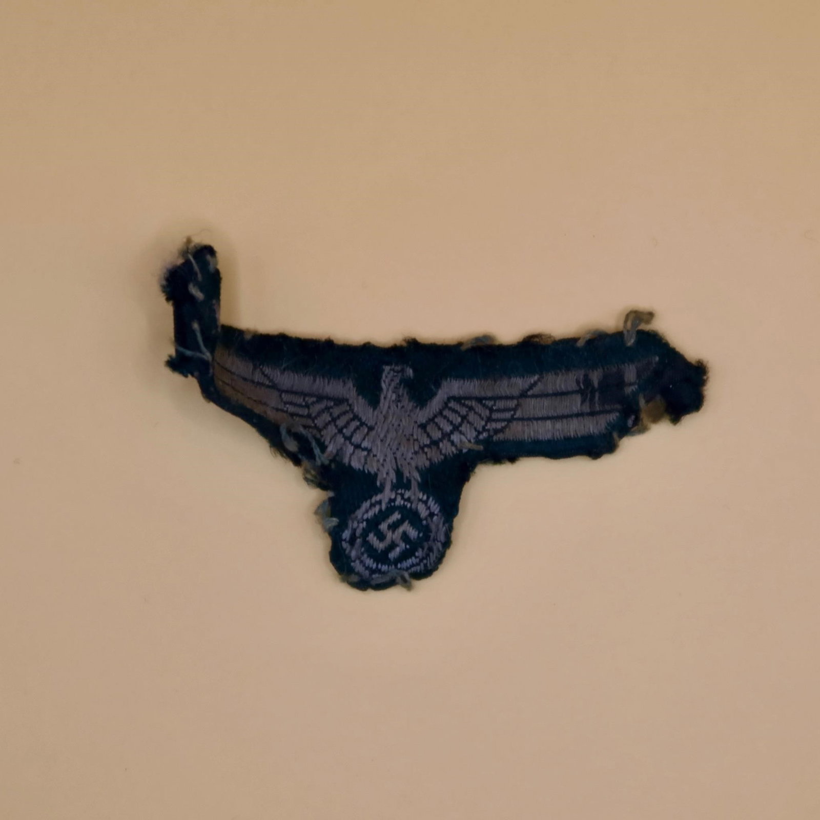 WWll Panzel Side Cap Eagle: German Army Panzer troops side cap eagle in the smaller size, BeVo-woven construction. Features a stylized national eagle in fine machine weave with crisp detail. Removed-from-uniform condition,