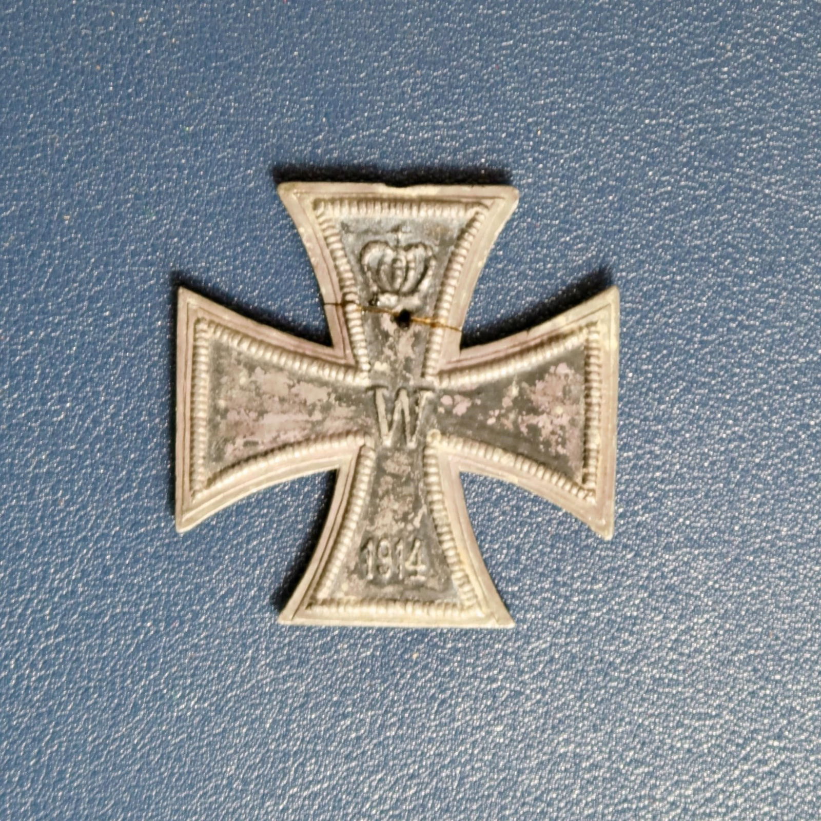 Type A 1870 Iron Cross 2nd Class (EK2): All-original iron core with strong detail and much of its original blackening, framed with slight wear to the beading and subtle rainbow toning to the outer flanges. The ring eyelet area at the top