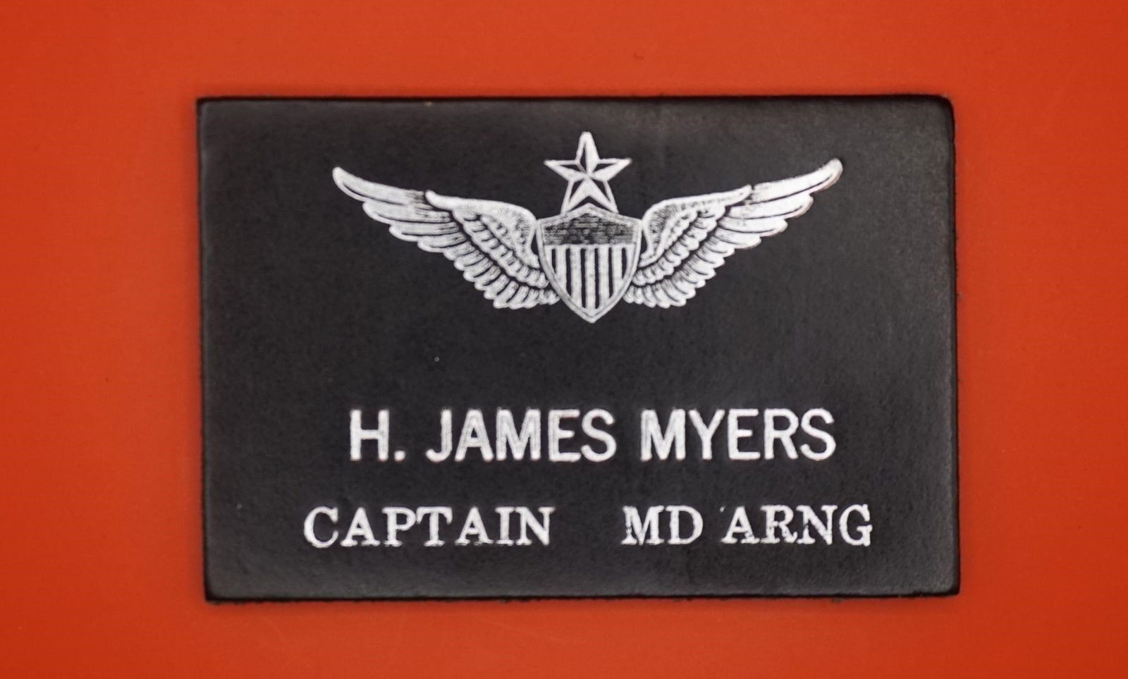 Custom Flight Suit Badge for Capt Myers (MD ARNG): This is a custom leather military flight suit name badge for H. James Myers, a Captain in the Maryland Army National Guard (MD ARNG). Made from genuine leather, typically 2x4 inches in size. Features
