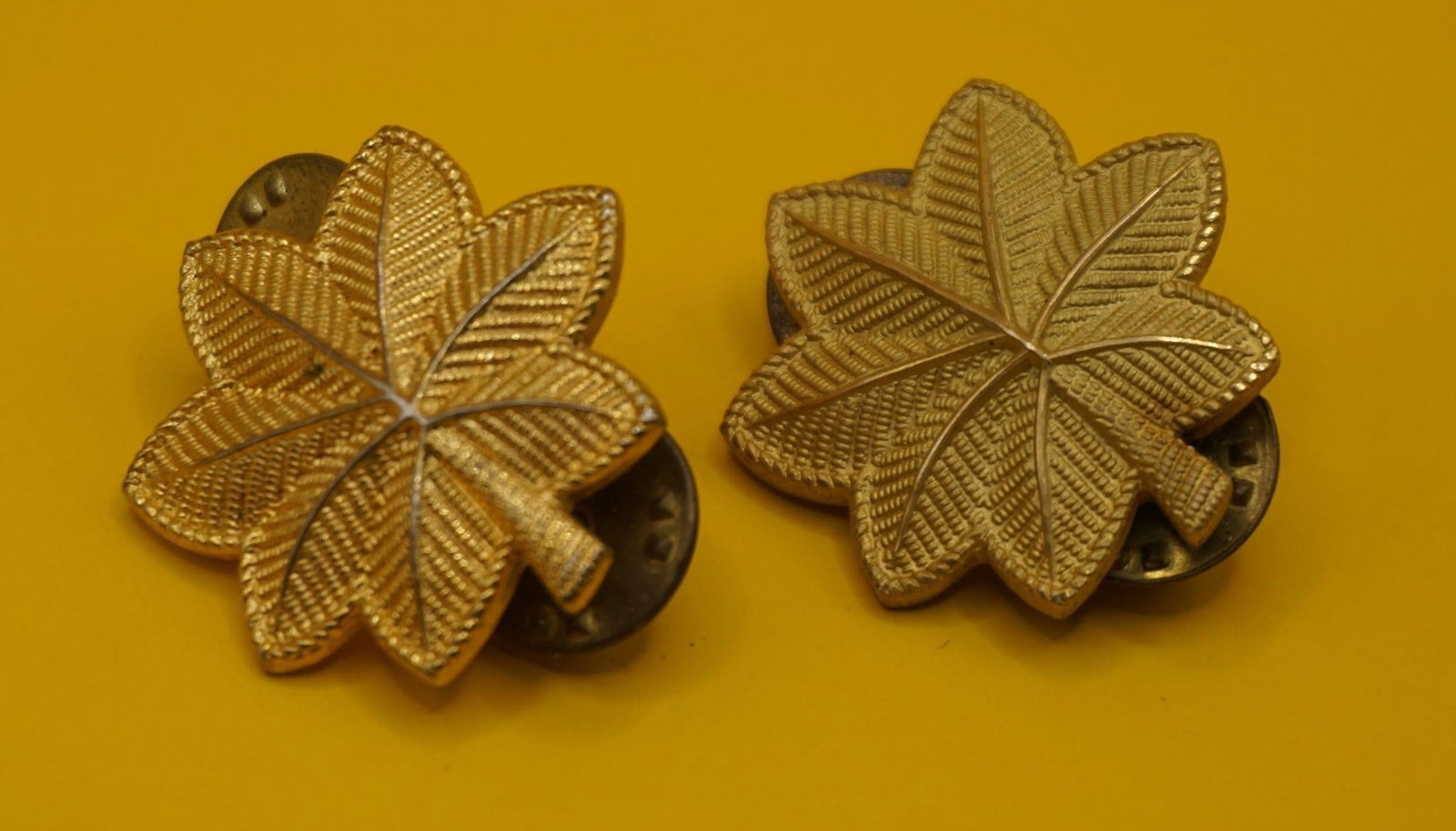 WWII US Army Major O4 Pay Grade Rank Insignia Pins: These are US Army Major (O-4 pay grade) rank insignia pins, featuring a gold-tone oak leaf design. Used to denote the rank of Major in the U.S. Army. The use of an oak leaf for the rank dates back to
