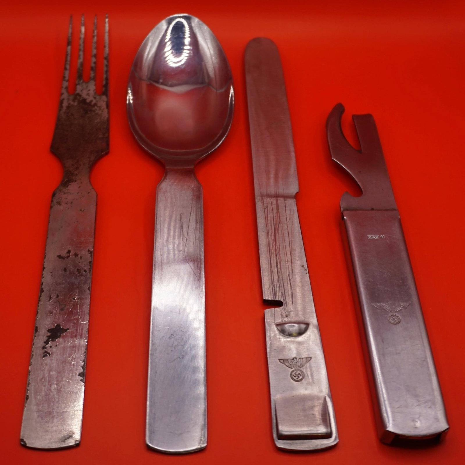 WWII German Wehrmacht Mess Kit Utensils Set: Original WWII German Wehrmacht mess kit utensils set, including knife, fork, spoon, and can opener, all stamped with Heer eagle. Knife, fork, and spoon marked "GAG" with wartime dates (1941-42).