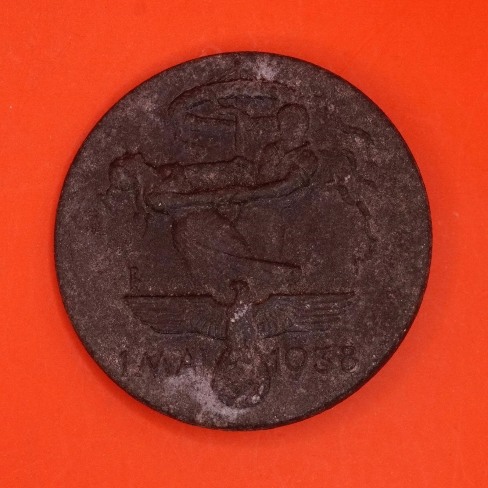 WWII GERMAN 1938 MAY DAY TINNIE: WWII GERMAN 1938 MAY DAY TINNIE. GOOD PIN BACK WITH HOOK CATCH.