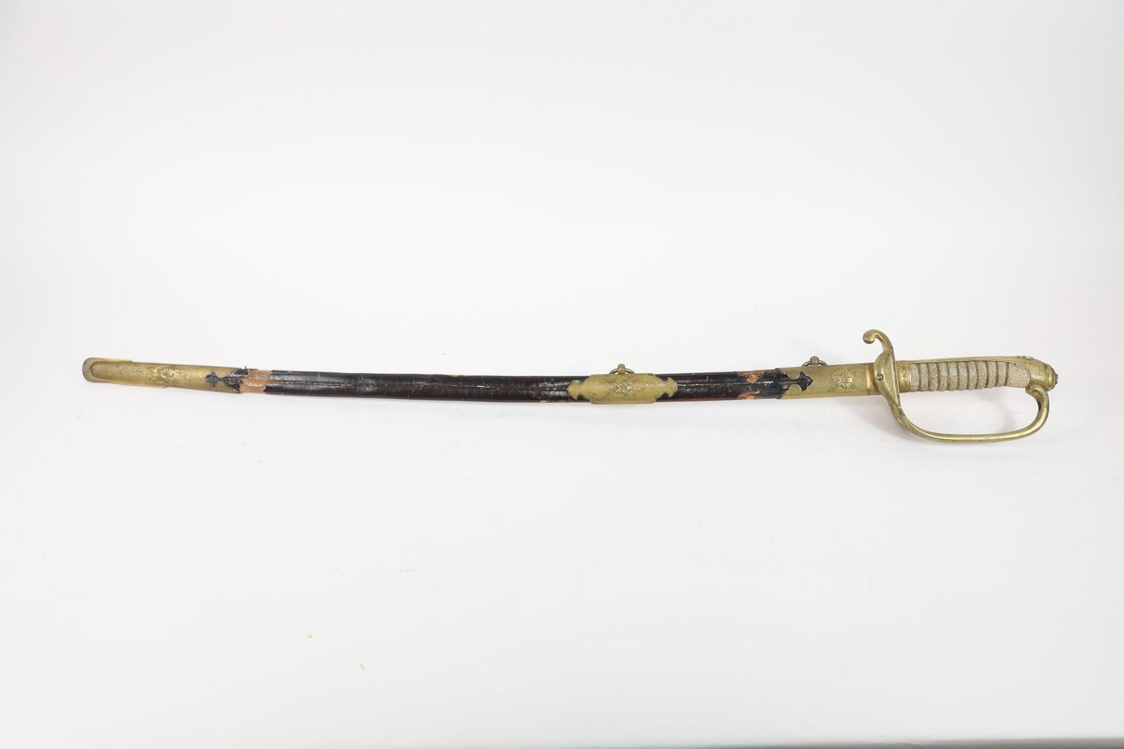 WWII Kyu-Gunto Japanese Naval Officer's Saber: Kyu-Gunto Japanese Naval Officer's Saber, Model 1883, Steel blade, slightly curved and single-edged, with one groove on each side and a nickel-plated finish. Brass hilt comprising a guard and handle.