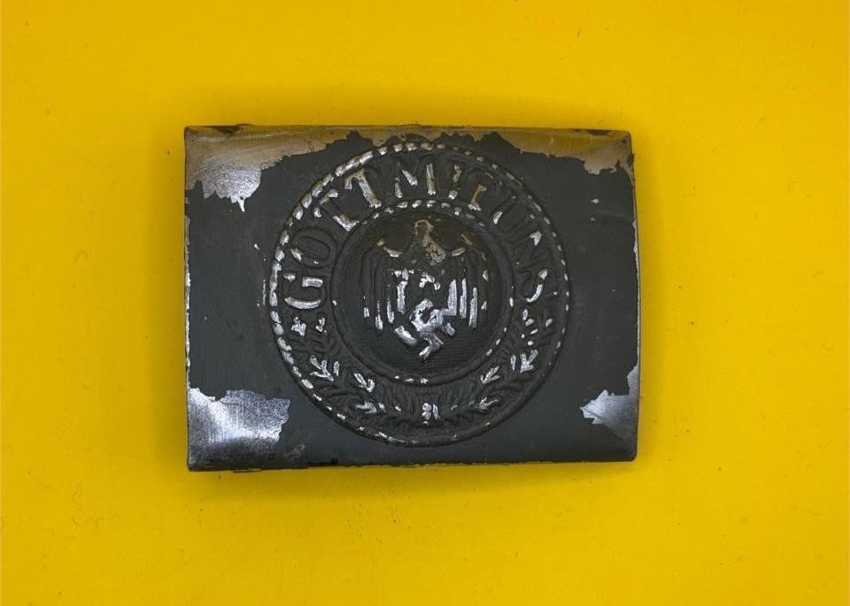 Late War Heer/Kriegsmarine Buckle: This late-war Heer/Kriegsmarine steel belt buckle features dark blue paint and intact reverse prongs, maker marked JFS. Produced for use by both the Heer and Kriegsmarine, it represents the