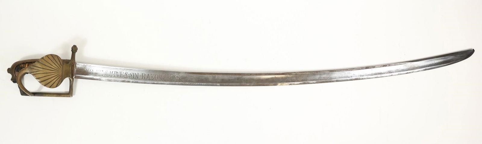18th c Spanish Colonial Sword Sin Honor Sin Razón: Antique Spanish Colonial Engraved Sword ca 18th Century.No Me Saques Sin RazonNo Me Embaines Sin Honor31 1/2" fuller blade, 36 7/8" overall length approx. Leather grip as you see."Sin honor, sin