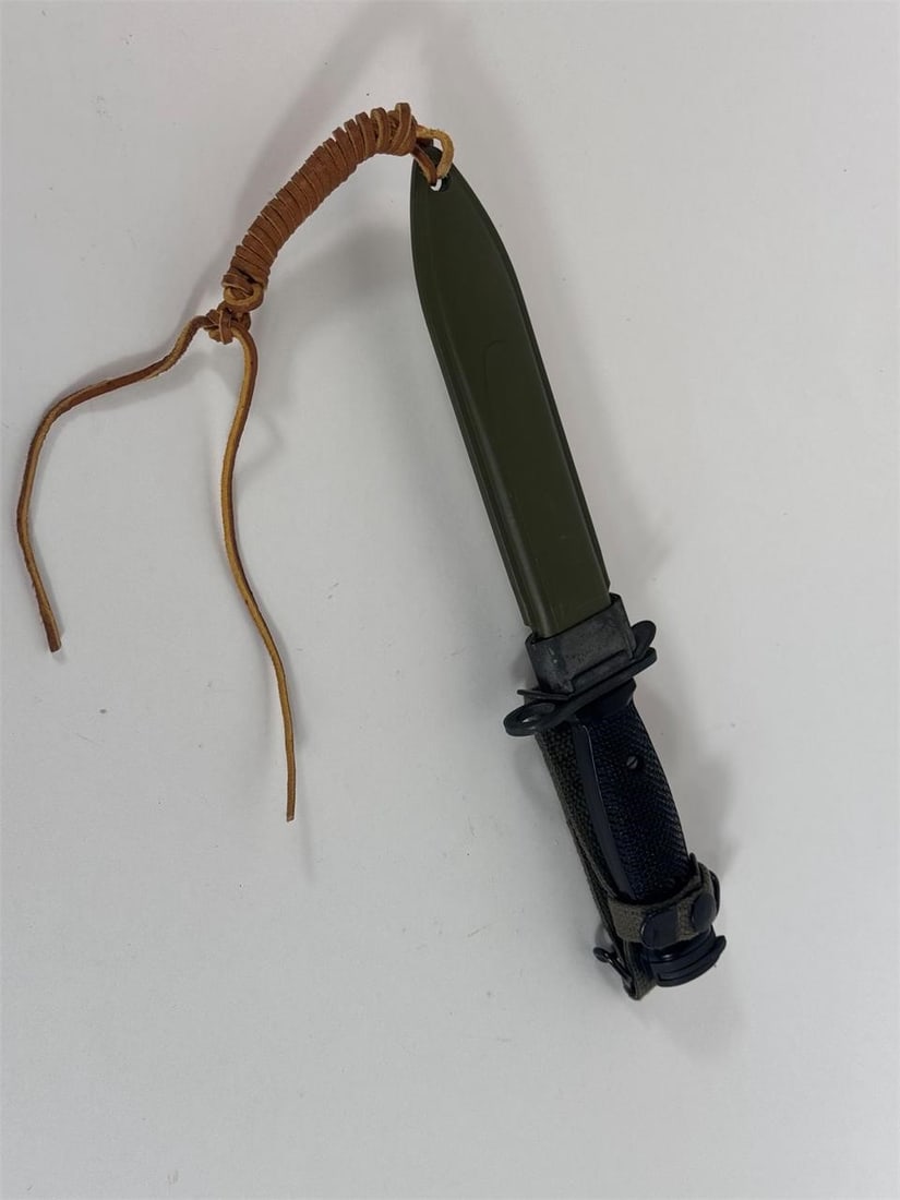 USM8AI Bayonet: The USM8A1 is primarily a bayonet scabbard, not a bayonet itself, made from olive drab webbing/plastic with a metal throat and M1910 wire hanger, designed to hold various US bayonets (M4, M5, M6, M7)