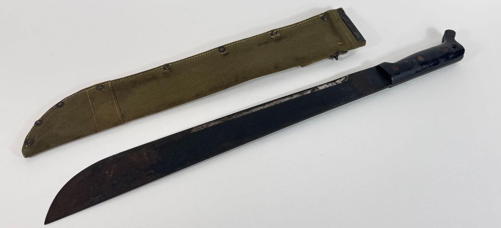 WWII Era US Army 18" Machete & Canvas Scabbard: The item you have is a WWII-era U.S. military 18-inch machete and canvas scabbard, a common piece of field gear used during the war. These were issued to various personnel, including Army soldiers and