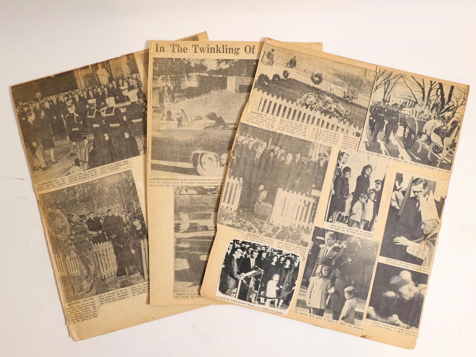 Vintage JFK Funeral Newspaper Clippings Lot: Collection of vintage newspaper pages and clippings covering the assassination and funeral of President John F. Kennedy in 1963. Includes historic images of the funeral procession, Arlington burial, a