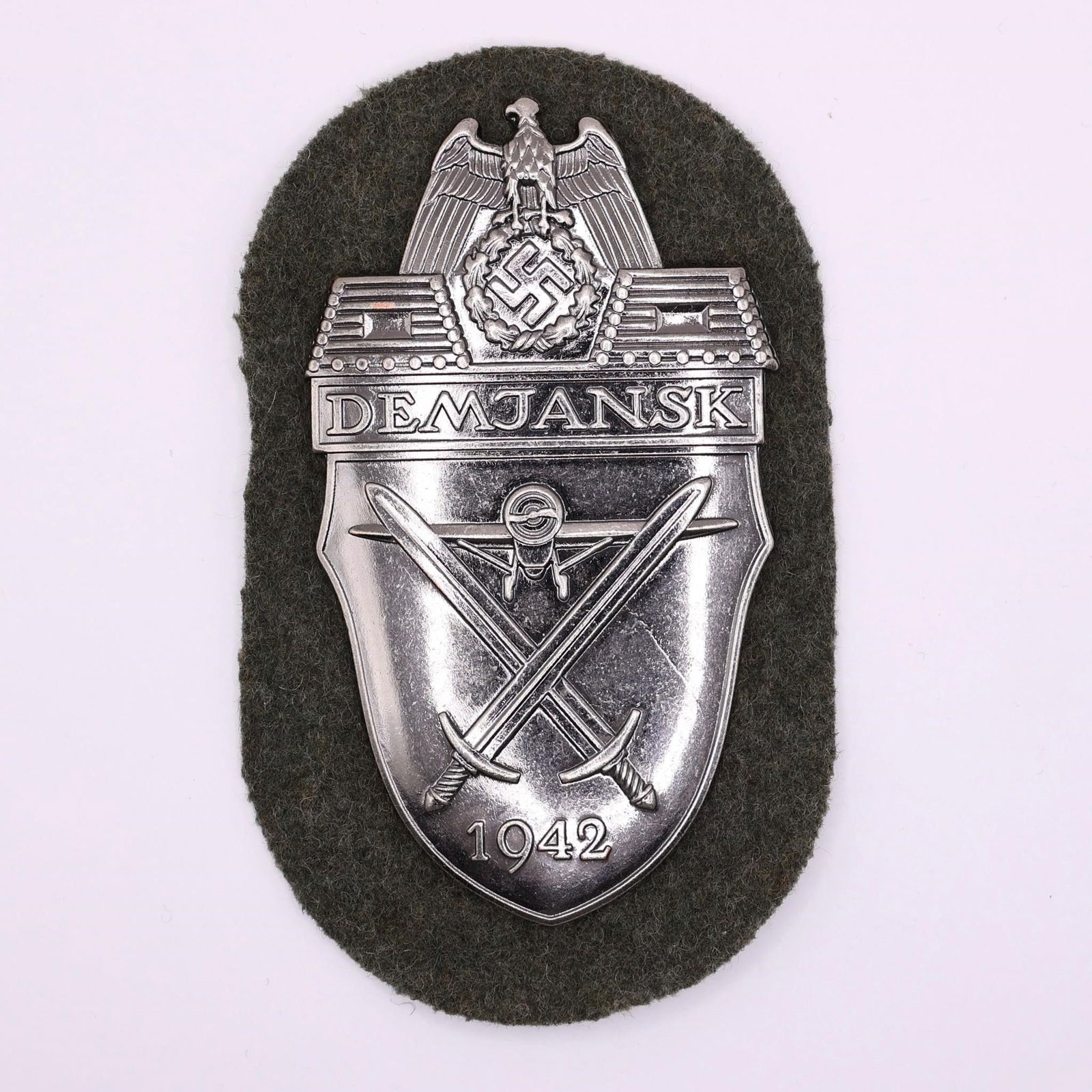 Demjansk Shield: Demjansk Shield, sewn onto original wool backing, commemorates German troops who fought in the Demyansk pocket (Feb 1942-Apr 1943) on the Eastern Front. Issued to Heer, SS, and supporting units, it