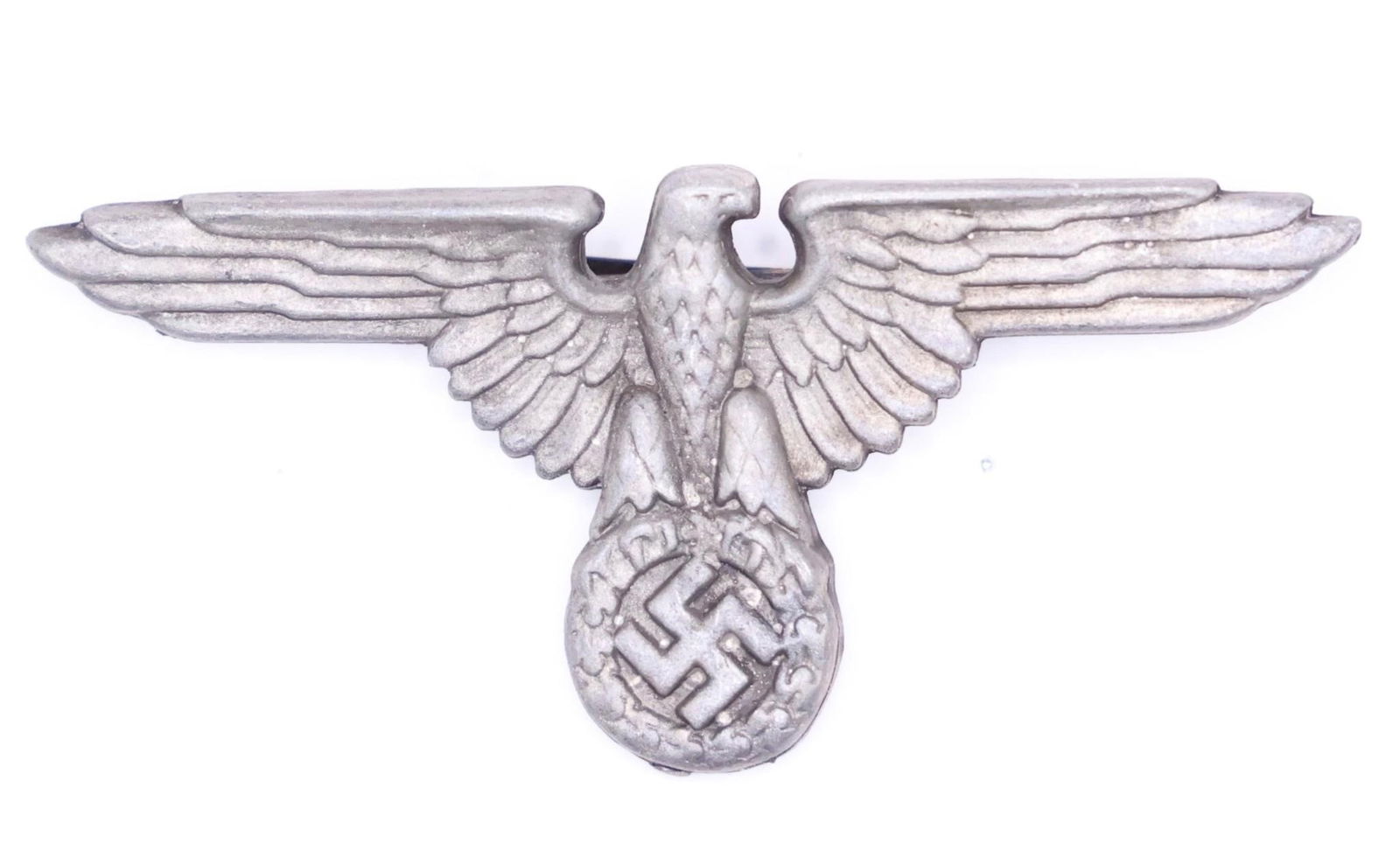 WWII German SS Officer Visor Cap Eagle: Introduced in 1936, the SS visor cap eagle replaced earlier designs to distinguish SS officers from the SA. Worn throughout World War II, it identified SS affiliation and rank, symbolizing the