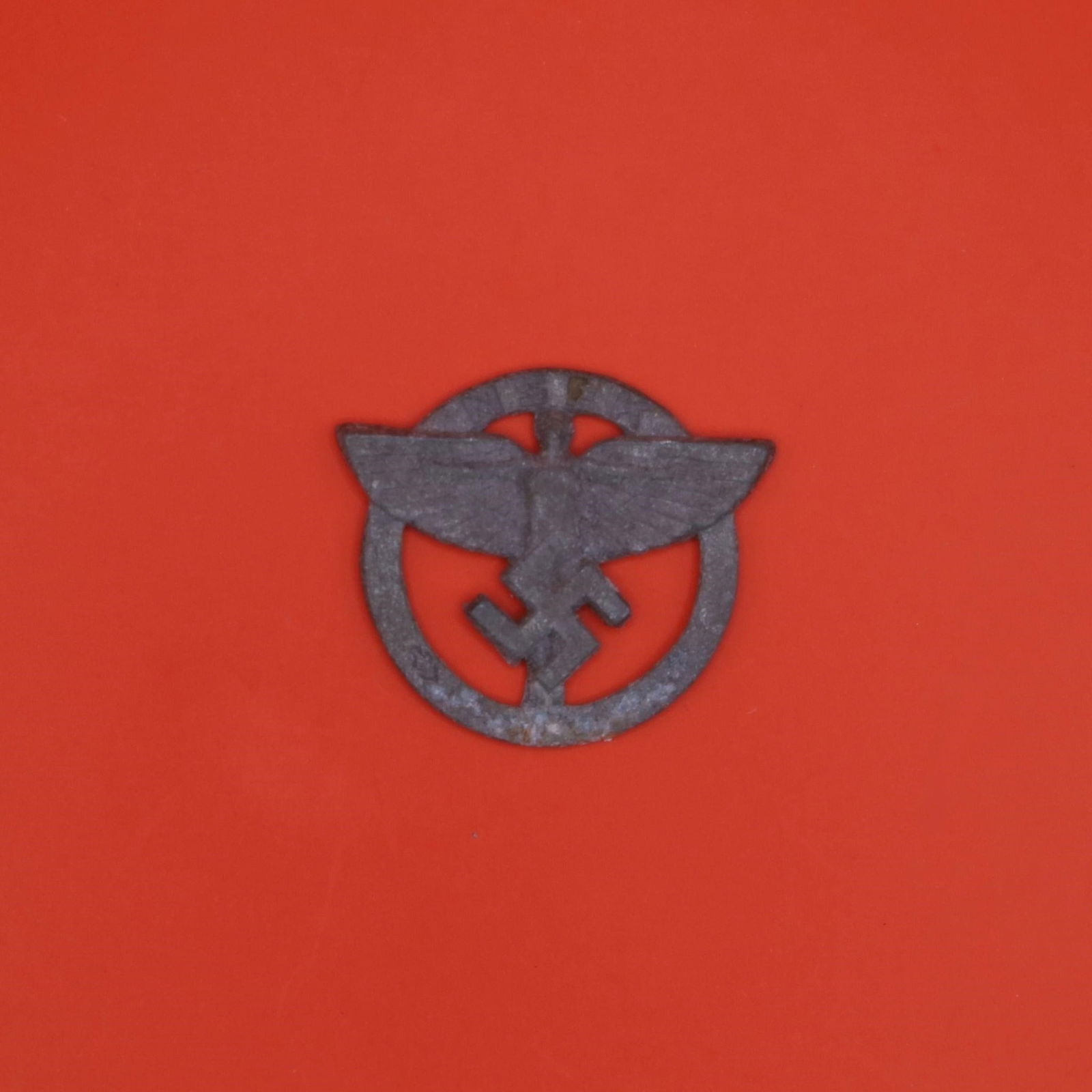 NSFK Member's Badge: This is a metal badge from the National Socialist Flyers Corps (NSFK), a paramilitary aviation organization active in Germany at the time. It features the group's winged-figure emblem within a circula