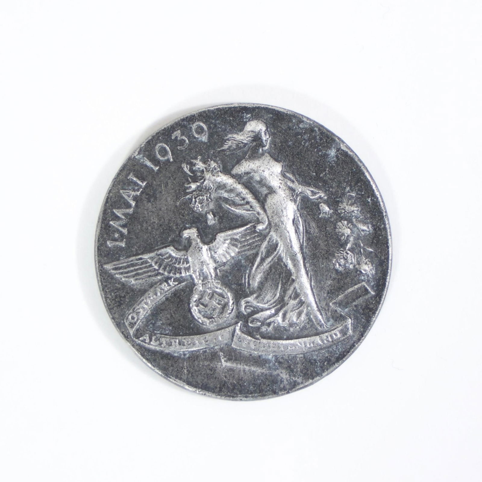 German National Day of Labour May 1 Tinnie Badge: This item is a German National Day of Labour badge (tinnie) from May 1, 1939, commemorating May Day. No pin on the back.