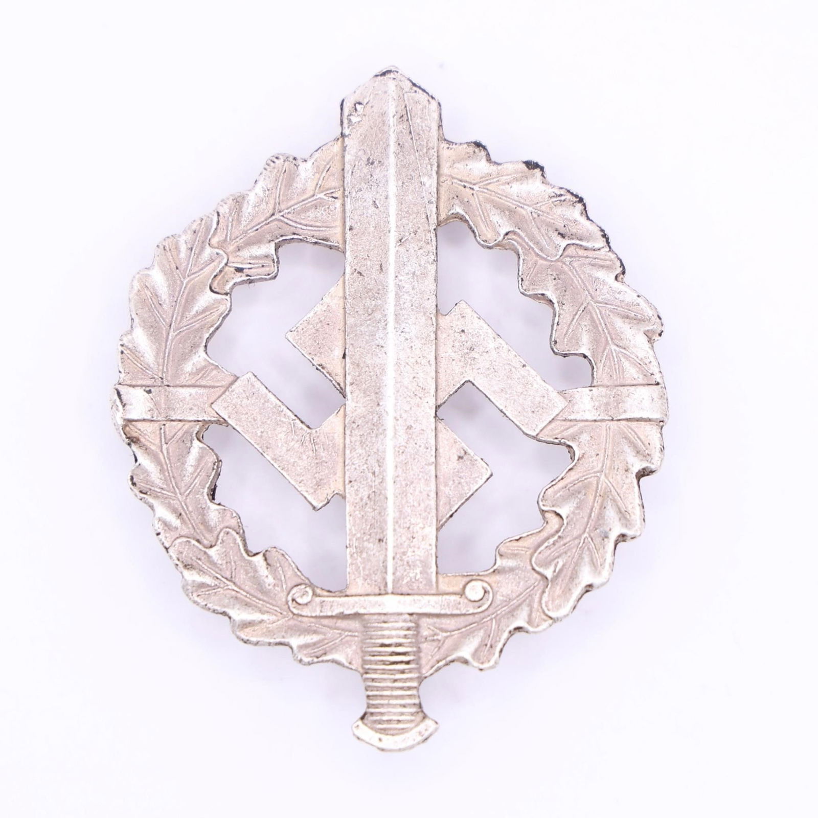German NSDAP SA/SS Sports Badge in Bronze: Die-struck, magnetic sheet-metal badge with bronze wash finish. Circular oak-leaf wreath enclosing an upward-pointing Roman broadsword superimposed over a canted swastika. Detailing includes veined