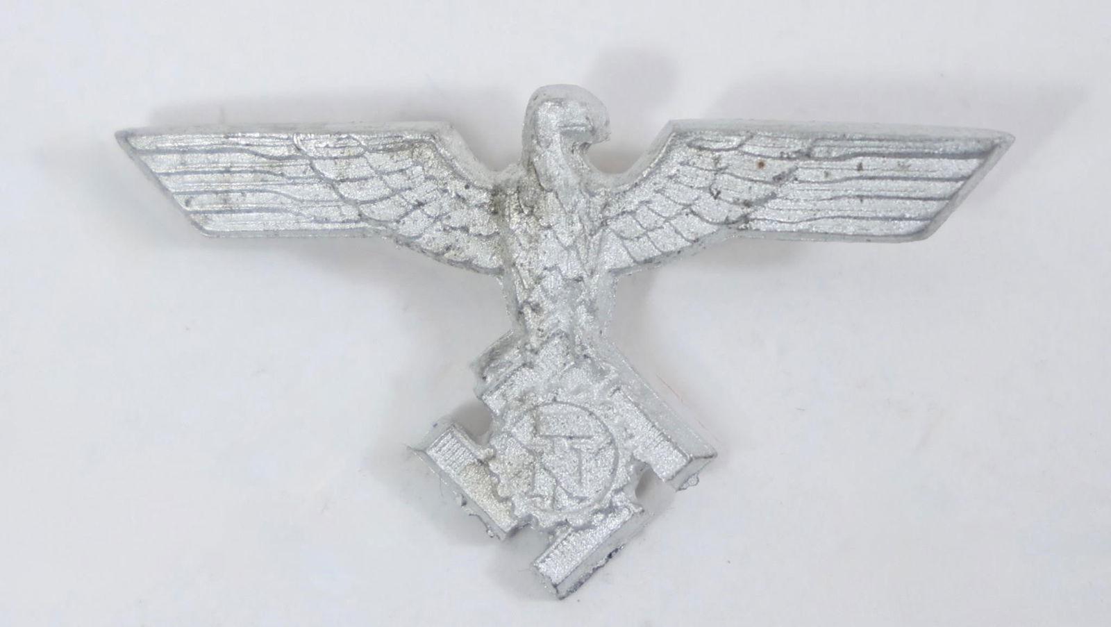 WWII German TeNo Officer Visor Cap Eagle Insignia: This image shows a World War II German Technische Nothilfe (TeNo) officer's visor cap eagle insignia.