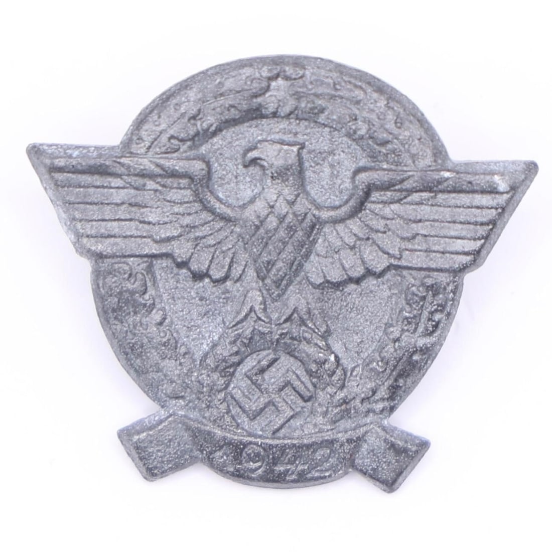1942 German Police Commemorative Tinnie: A small die-cast zinc badge featuring the wartime police eagle within a wreath. These were issued for the 1942 "Day of the Police" event and were typically worn as inexpensive donation pins. The