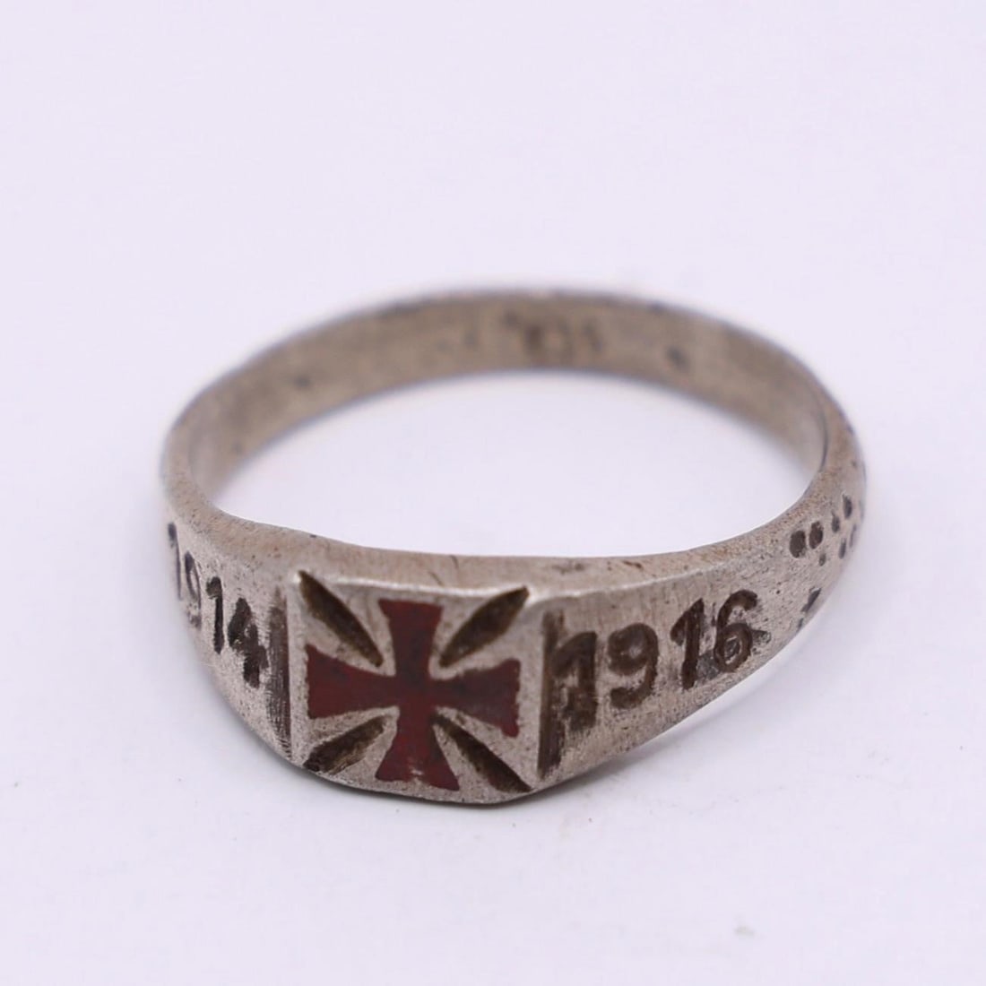 WWI German Silver Ring 1914-1916: WWI German Silver Ring featuring engraved dates "1914" and "1916" flanking a central cross motif. The design is sharp, with natural age wear that adds character. Marked 635 inside the band. A classic
