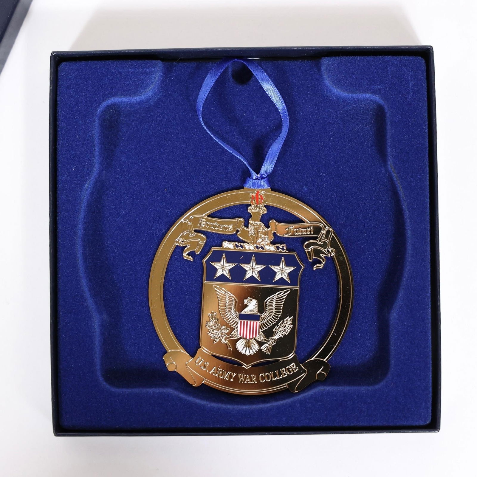 U.S. Army War College Ornament: Gold-tone metal ornament, likely made of brass or a similar plated alloy, often created as an annual collectible or fundraiser keepsake.Dimensions: 5 1/4in x 5 1/4in x 1in