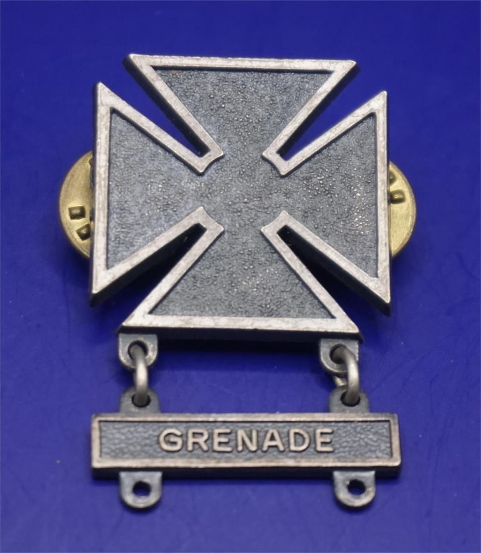 WWII US Army Marksman Grenade Qualification Bar: This is a US Army Marksman qualification badge with a "Grenade" qualification bar. The badge is awarded to military personnel who achieve a basic level of proficiency with a specific weapon. The