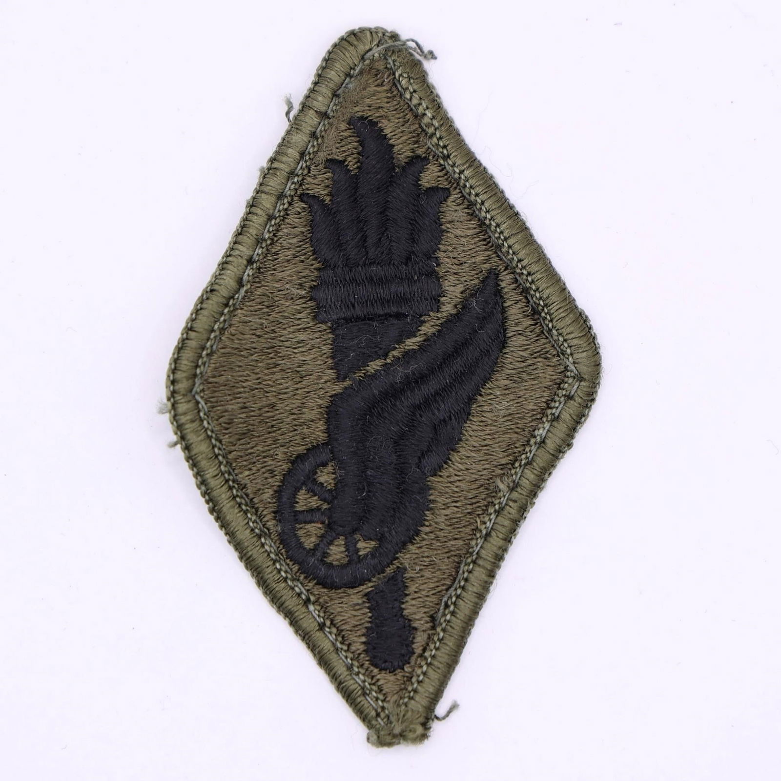 Subdued U.S. Army Transportation School Patch: Subdued U.S. Army Transportation School shoulder sleeve insignia patch. The patch features a winged wheel surmounted on a flaming torch, which is the branch insignia of the Transportation Corps. The