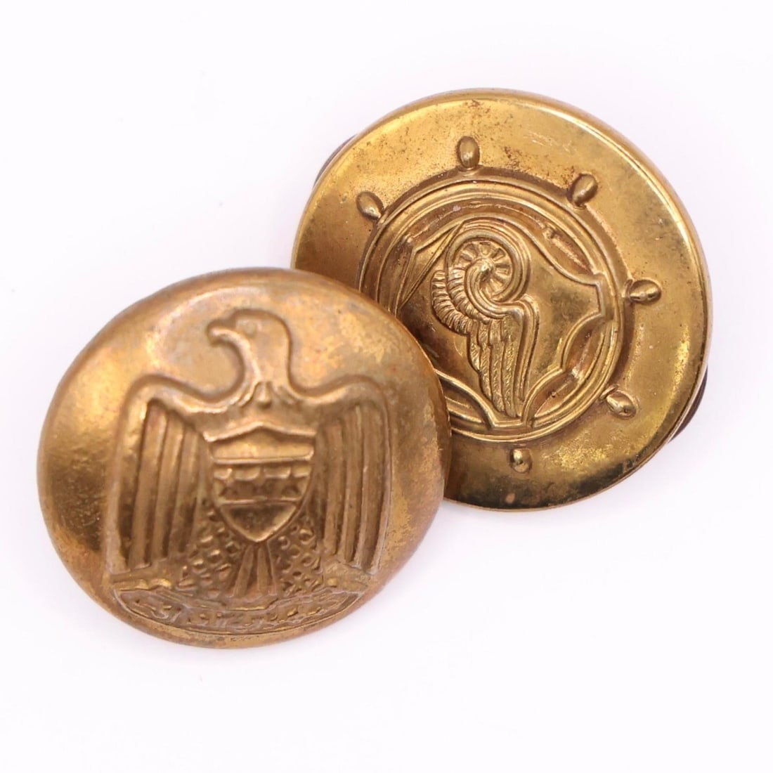 WWII US Army Transportation Corps Collar Pin: This is an original US Army Transportation Corps collar pin or badge, from the World War II era. The insignia features a ship's steering wheel, a shield, and a winged car wheel on a rail, symbolizing