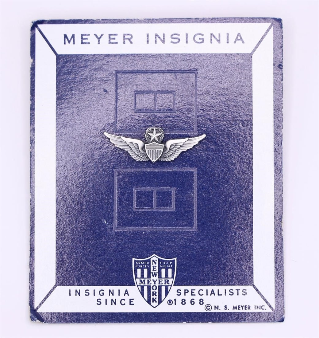 US Army Basic Flight Surgeon Badge by NS Meyer: This is a United States Army Basic Flight Surgeon Badge manufactured by N. S. Meyer Inc. The badge features a shield bearing the Staff of Aesculapius over a pair of wings, symbolizing medical skills a