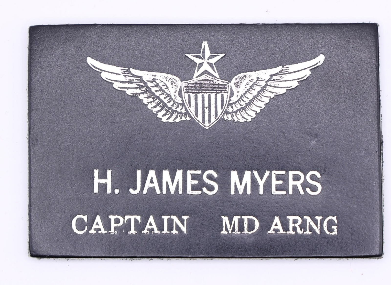 Custom Flight Suit Badge for Capt Myers (MD ARNG): This is a custom leather military flight suit name badge for H. James Myers, a Captain in the Maryland Army National Guard (MD ARNG). Made from genuine leather, typically 2x4 inches in size. Features