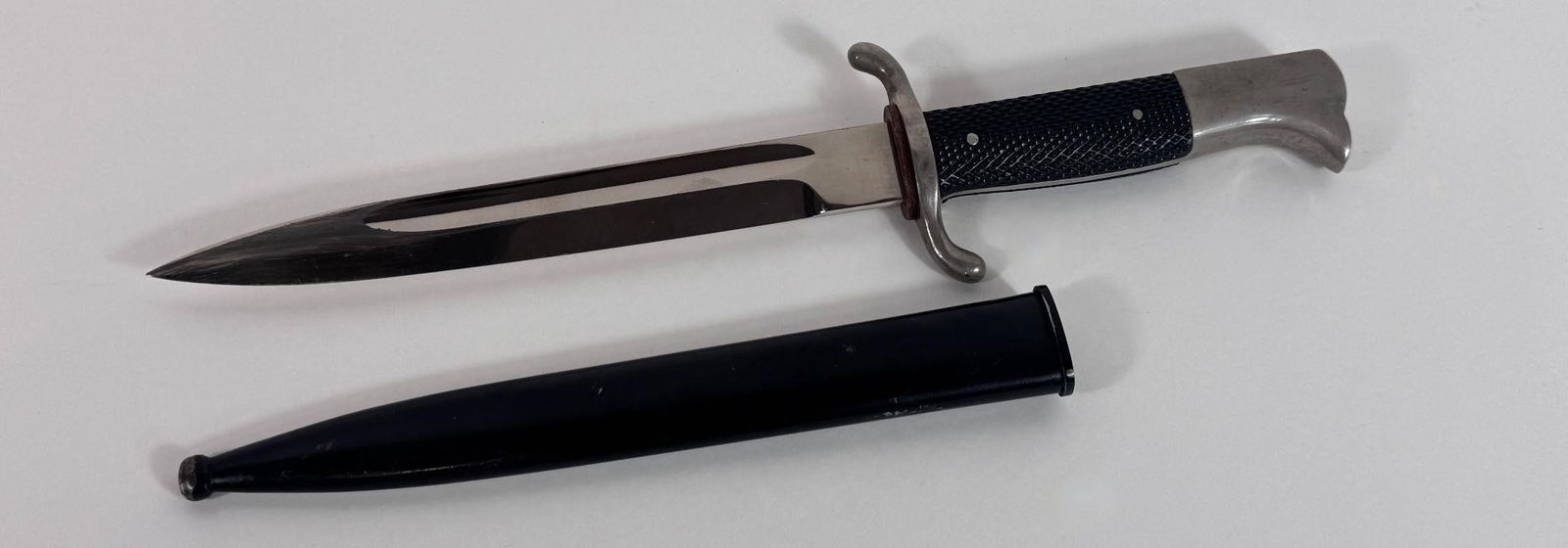 WWII German n/m Dress Bayonet with Scabbard: German dress bayonet, specifically a type often associated with the Wehrmacht (German armed forces) or fire protection police (Feuerschutzpolizei) during the World War II era. These were privately pur